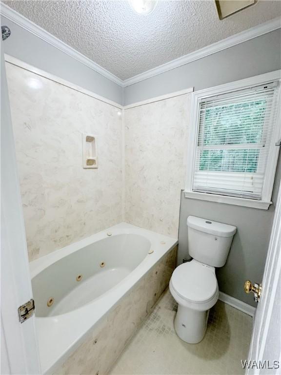 bathroom featuring toilet, a textured ceiling, and ornamental molding