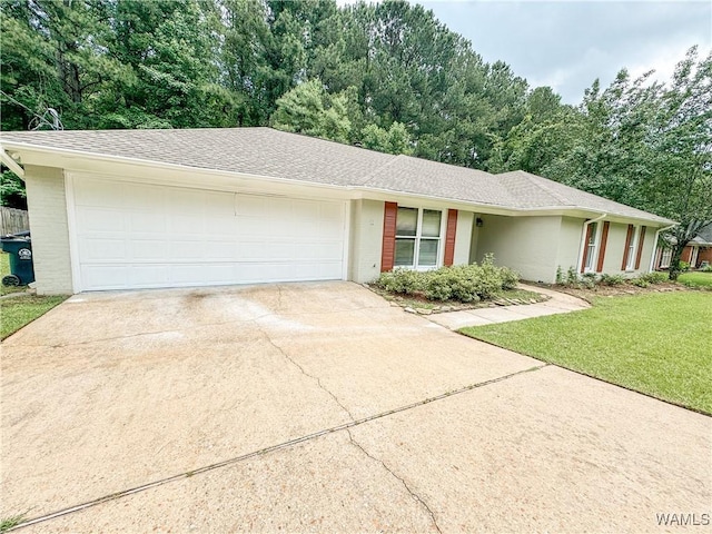 ranch-style home with a front yard and a garage