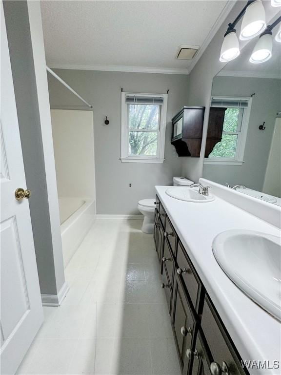 bathroom featuring tile patterned floors, vanity, a healthy amount of sunlight, and toilet