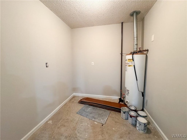 laundry area featuring a textured ceiling and water heater