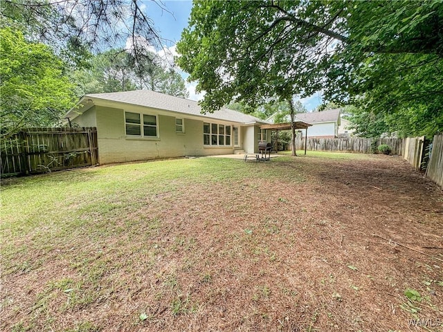 back of house featuring a patio and a lawn