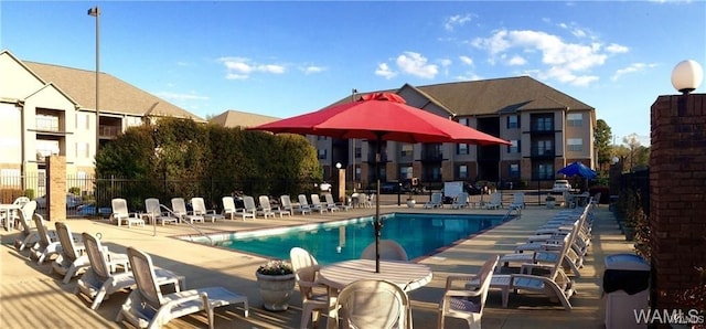 pool featuring a patio area and fence