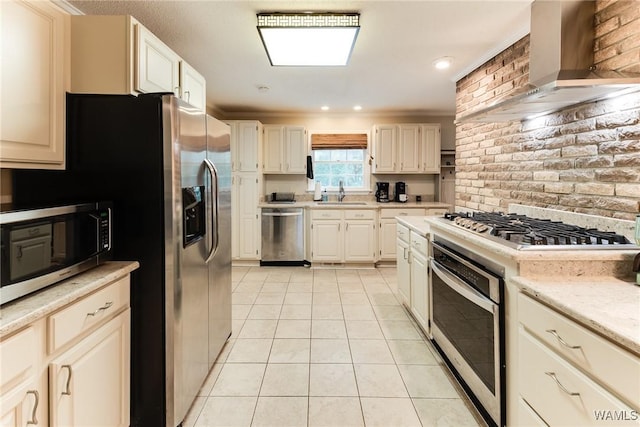4809 Dove Creek Ave, Northport, AL 35473 - kitchen with appliances with stainless steel finishes, wall chimney exhaust hood, light tile patterned flooring, brick wall, and ornamental molding