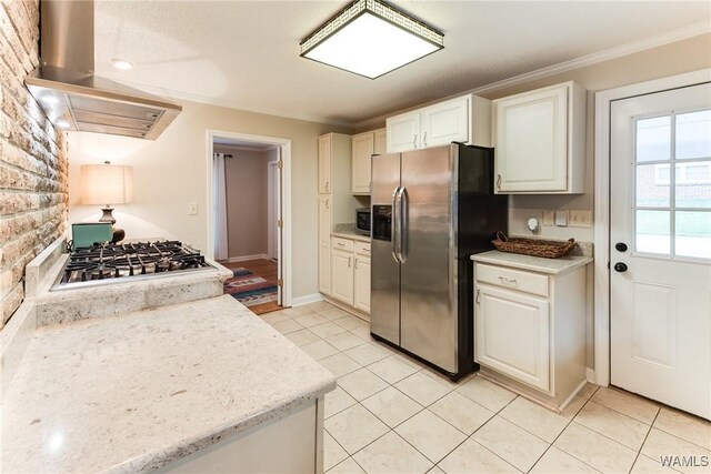 4809 Dove Creek Ave, Northport, AL 35473 - kitchen with stainless steel appliances, ventilation hood, crown molding, light tile patterned floors, and white cabinets