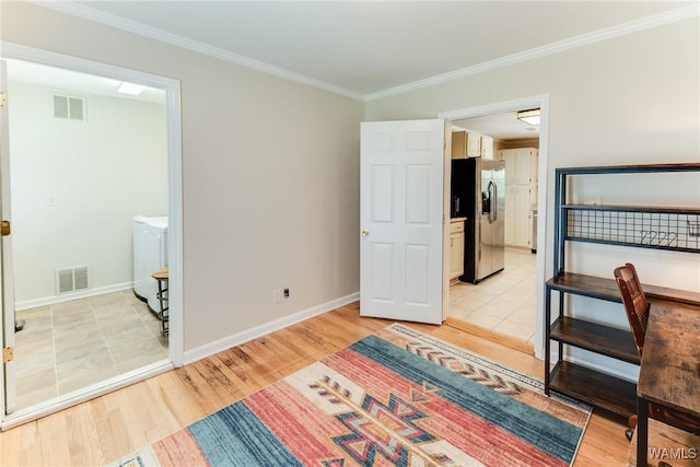 4809 Dove Creek Ave, Northport, AL 35473 - unfurnished bedroom featuring stainless steel fridge, light wood-style floors, ornamental molding, and separate washer and dryer
