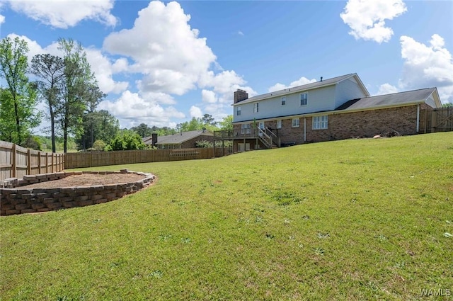 view of yard featuring a fenced backyard and stairway