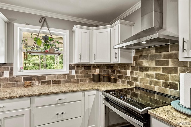 17631 Hayes Rd, Northport, AL 35475 - kitchen with wall chimney exhaust hood, stainless steel range with electric cooktop, ornamental molding, white cabinets, and backsplash