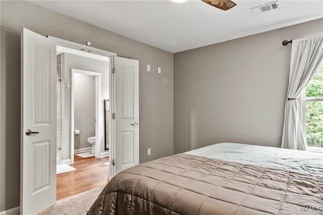 17631 Hayes Rd, Northport, AL 35475 - bedroom with light wood-type flooring, baseboards, and connected bathroom