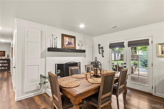 2507 Twin Mnr, Northport, AL 35476 - dining space with a fireplace, french doors, crown molding, dark wood-style flooring, and recessed lighting