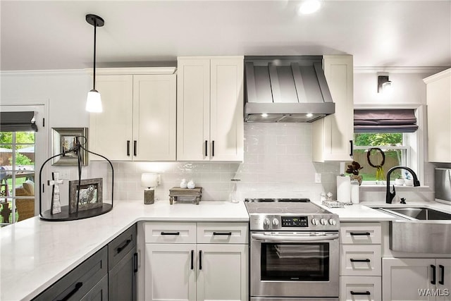 2507 Twin Mnr, Northport, AL 35476 - kitchen with stainless steel electric stove, wall chimney exhaust hood, a sink, healthy amount of natural light, and crown molding