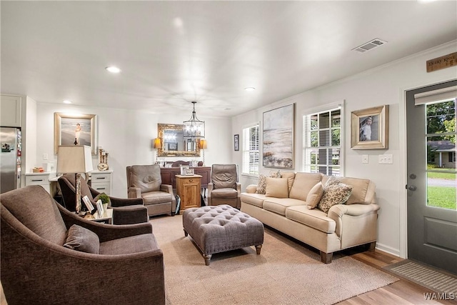 2507 Twin Mnr, Northport, AL 35476 - living room with a chandelier, light wood finished floors, recessed lighting, ornamental molding, and baseboards