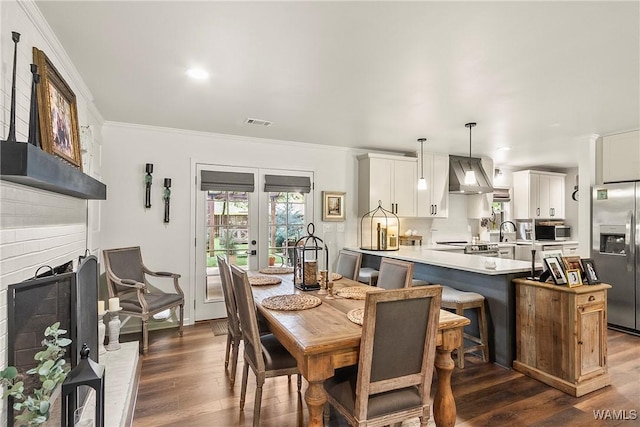 2507 Twin Mnr, Northport, AL 35476 - dining area featuring crown molding, dark wood finished floors, and french doors
