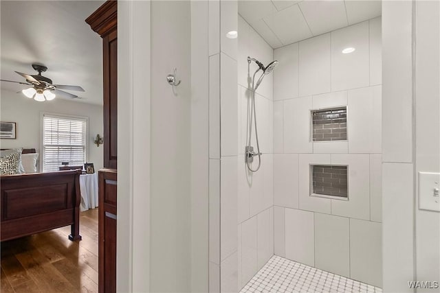 2507 Twin Mnr, Northport, AL 35476 - full bath featuring tiled shower, a ceiling fan, and wood finished floors
