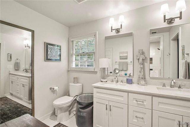 2507 Twin Mnr, Northport, AL 35476 - full bathroom with toilet, double vanity, baseboards, and tile patterned floors