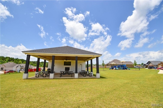 13946 Sullivan Blvd, Northport, AL 35475 - rear view of house featuring a patio area, a yard, and a shingled roof