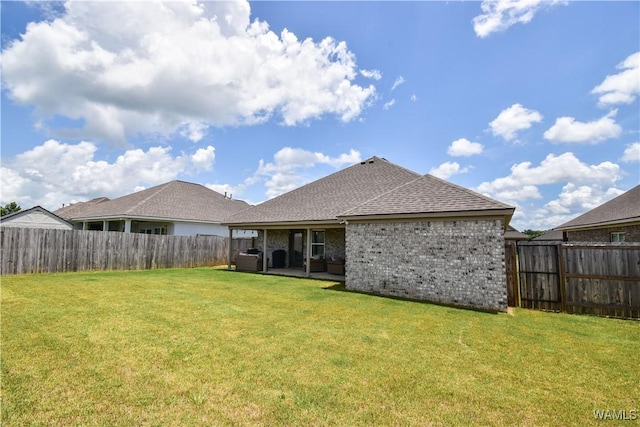 13946 Sullivan Blvd, Northport, AL 35475 - back of house featuring a fenced backyard, roof with shingles, a patio, and brick siding