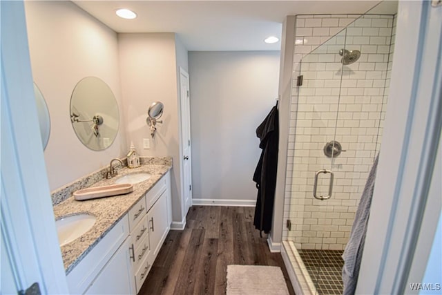 13946 Sullivan Blvd, Northport, AL 35475 - bathroom featuring a stall shower, wood finished floors, double vanity, and recessed lighting
