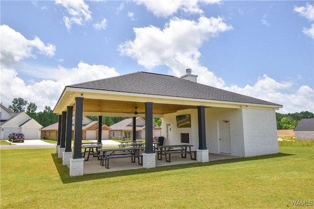 13946 Sullivan Blvd, Northport, AL 35475 - back of house with a lawn, ceiling fan, a chimney, and brick siding