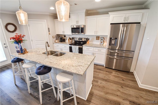 13946 Sullivan Blvd, Northport, AL 35475 - kitchen with stainless steel appliances, white cabinetry, dark wood-style flooring, an island with sink, and crown molding