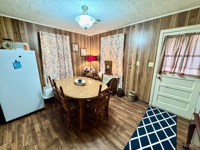 1002 Cedar Crest Dr, Demopolis, AL 36732 - dining area featuring wooden walls, visible vents, and wood finished floors