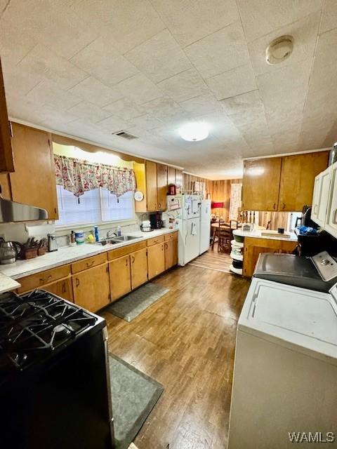 1002 Cedar Crest Dr, Demopolis, AL 36732 - kitchen with light countertops, light wood-style flooring, black gas range, and freestanding refrigerator