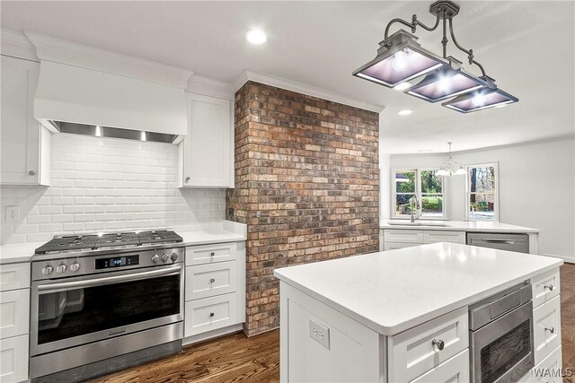 kitchen with a center island, sink, white cabinets, and appliances with stainless steel finishes