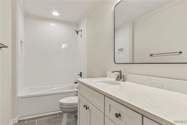 full bathroom with vanity, tiled shower / bath combo, toilet, and crown molding