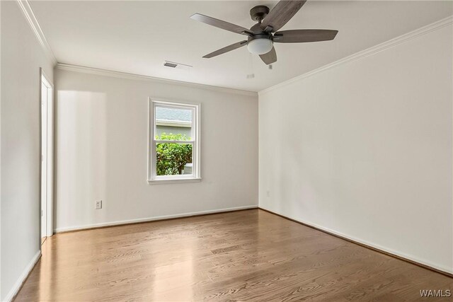 empty room with ceiling fan, ornamental molding, and hardwood / wood-style flooring