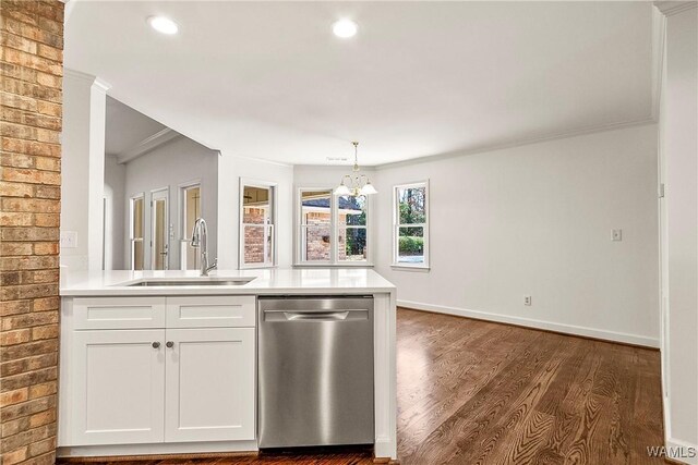 kitchen with white cabinets, stainless steel dishwasher, crown molding, and sink