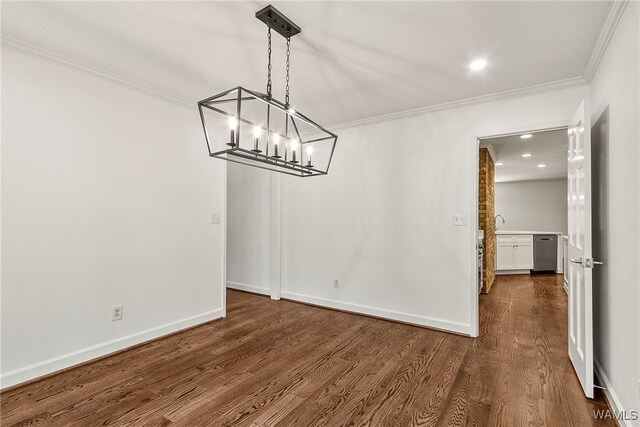 unfurnished dining area featuring a chandelier, dark hardwood / wood-style flooring, and ornamental molding