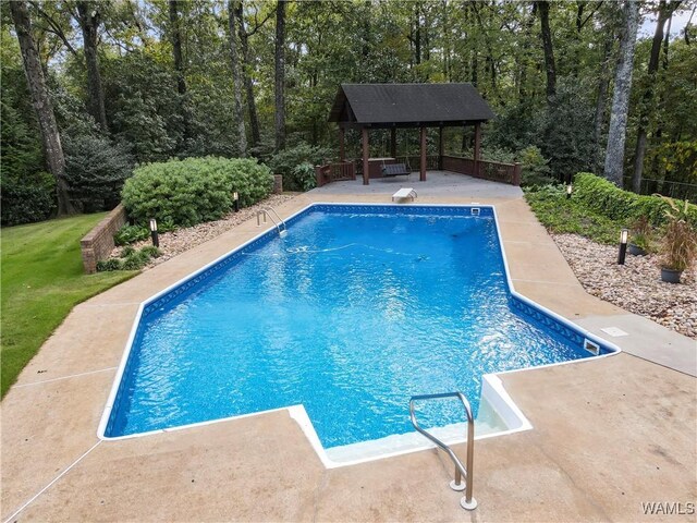 view of swimming pool with a gazebo, a diving board, and a patio