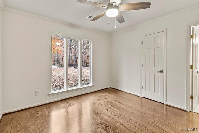 spare room featuring ceiling fan, light hardwood / wood-style floors, and ornamental molding