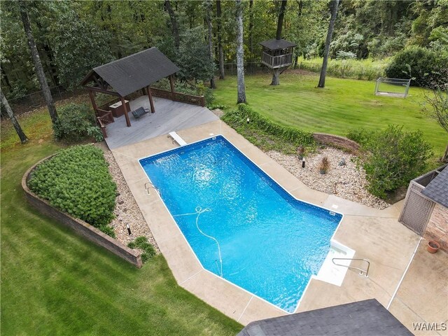 view of swimming pool with a gazebo, a diving board, a patio area, and a lawn