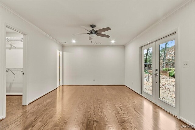 unfurnished room with french doors, light hardwood / wood-style flooring, ceiling fan, and ornamental molding