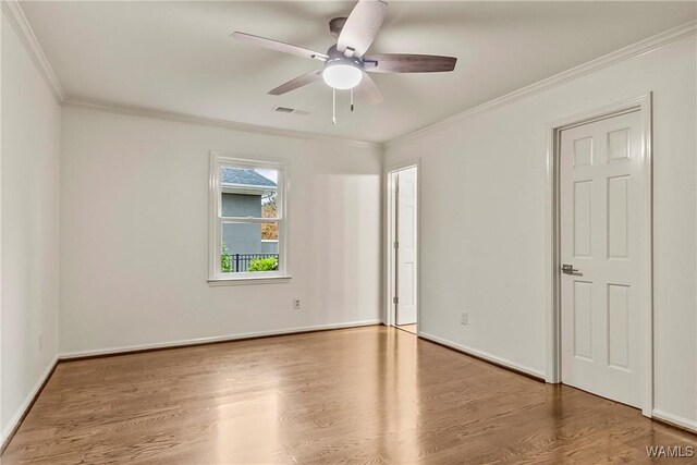 unfurnished room with hardwood / wood-style floors, ceiling fan, and crown molding