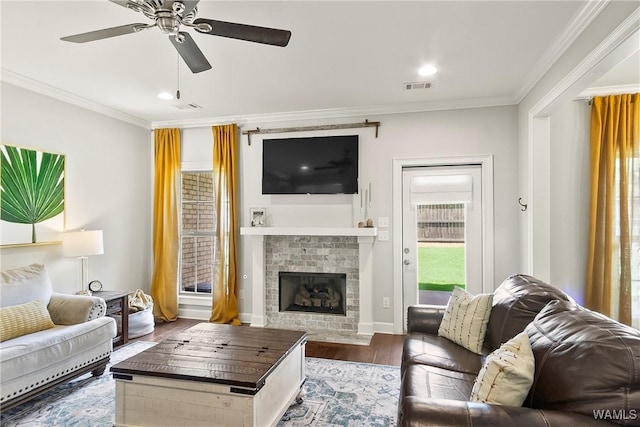 11441 Stella Way, Northport, AL 35475 - living area featuring a ceiling fan, a fireplace with flush hearth, wood finished floors, ornamental molding, and recessed lighting