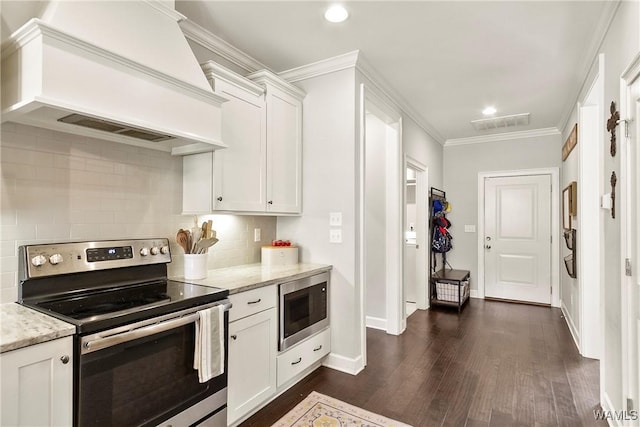11441 Stella Way, Northport, AL 35475 - kitchen with appliances with stainless steel finishes, custom exhaust hood, dark wood-style floors, tasteful backsplash, and white cabinets