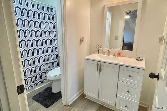 6400 Plantation Ct, Tuscaloosa, AL 35405 - full bathroom with a shower with curtain, baseboards, toilet, vanity, and wood finished floors