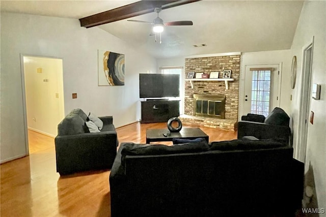 6400 Plantation Ct, Tuscaloosa, AL 35405 - living room with a ceiling fan, a brick fireplace, vaulted ceiling with beams, and wood finished floors