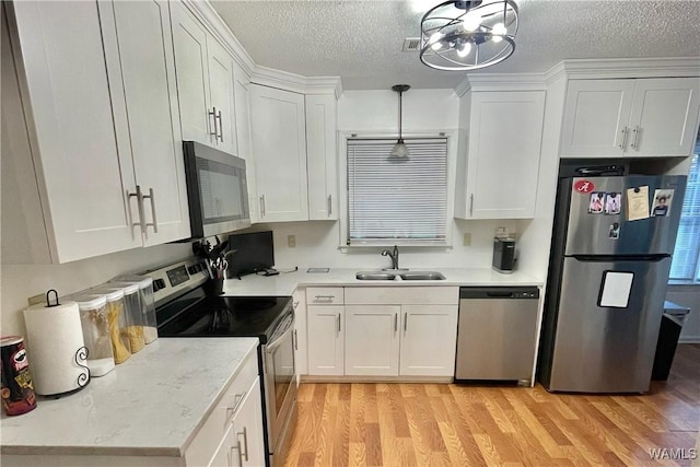 6400 Plantation Ct, Tuscaloosa, AL 35405 - kitchen with white cabinets, light wood-style floors, appliances with stainless steel finishes, and a sink
