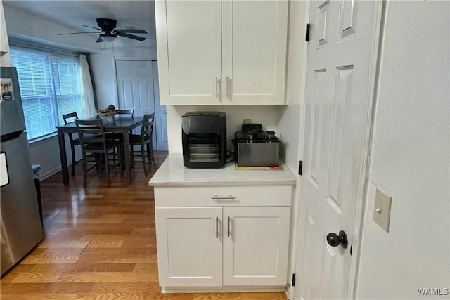 6400 Plantation Ct, Tuscaloosa, AL 35405 - interior space with freestanding refrigerator, light wood-style flooring, white cabinetry, light countertops, and a ceiling fan