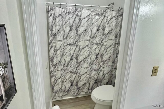 6400 Plantation Ct, Tuscaloosa, AL 35405 - bathroom with toilet, a shower with shower curtain, and wood finished floors
