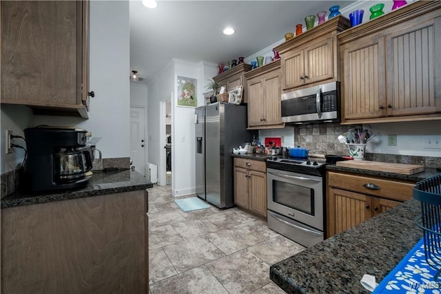 3215 Birch Way, Northport, AL 35475 - kitchen with stainless steel appliances, backsplash, dark stone counters, recessed lighting, and brown cabinets