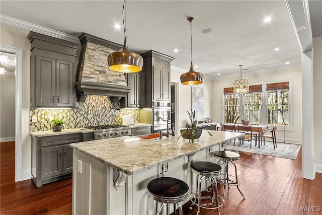 1006 Shady Tree Ln, Tuscaloosa, AL 35406 - kitchen featuring a notable chandelier, a sink, light stone countertops, range, and decorative backsplash