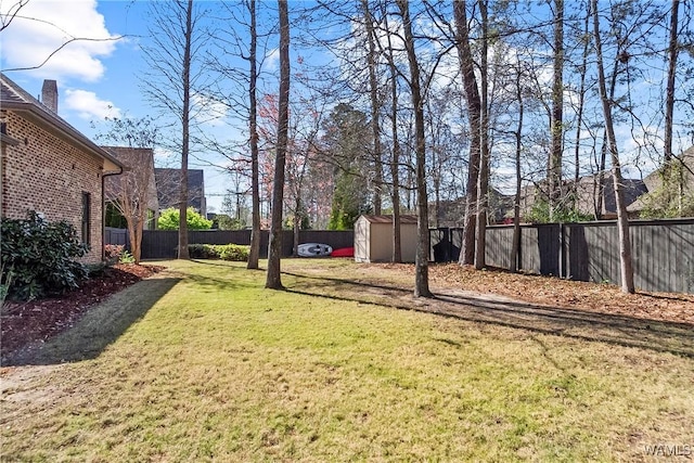 1006 Shady Tree Ln, Tuscaloosa, AL 35406 - view of yard with a storage unit, a fenced backyard, and an outdoor structure
