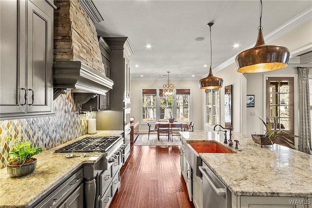 1006 Shady Tree Ln, Tuscaloosa, AL 35406 - kitchen featuring a large island with sink, ornamental molding, decorative backsplash, light stone countertops, and appliances with stainless steel finishes