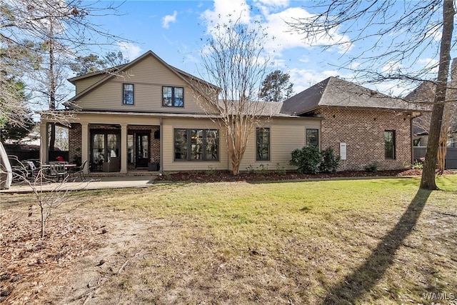 1006 Shady Tree Ln, Tuscaloosa, AL 35406 - rear view of property with a lawn, brick siding, and a patio