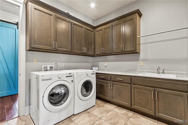 1006 Shady Tree Ln, Tuscaloosa, AL 35406 - laundry area with light tile patterned flooring, cabinet space, a sink, and separate washer and dryer