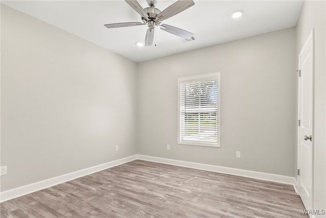 spare room featuring light wood-type flooring and ceiling fan