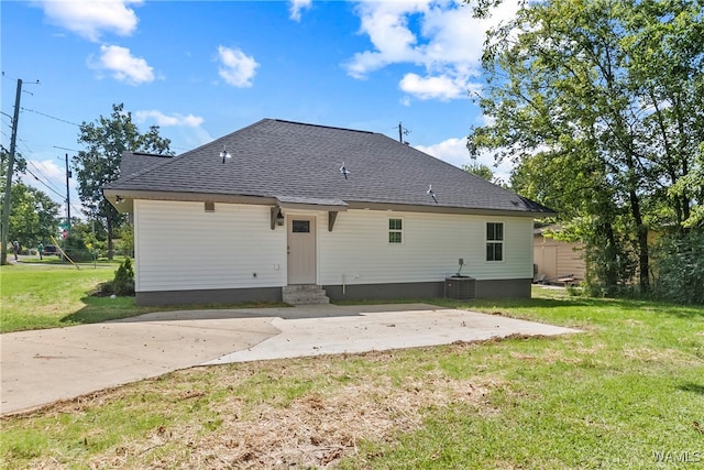 rear view of house with a yard and central AC unit